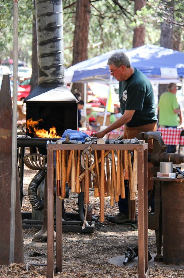 a blacksmith at work at a festival