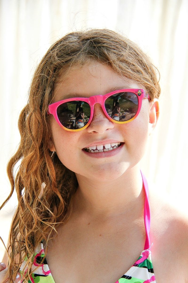 a girl wearing despicable me pink sunglasses