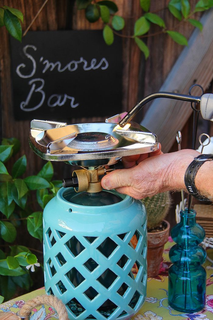 a portable camp stove being lit