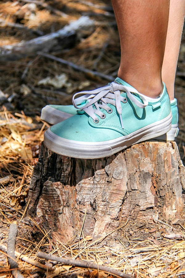 girl wearing aqua vans shoes