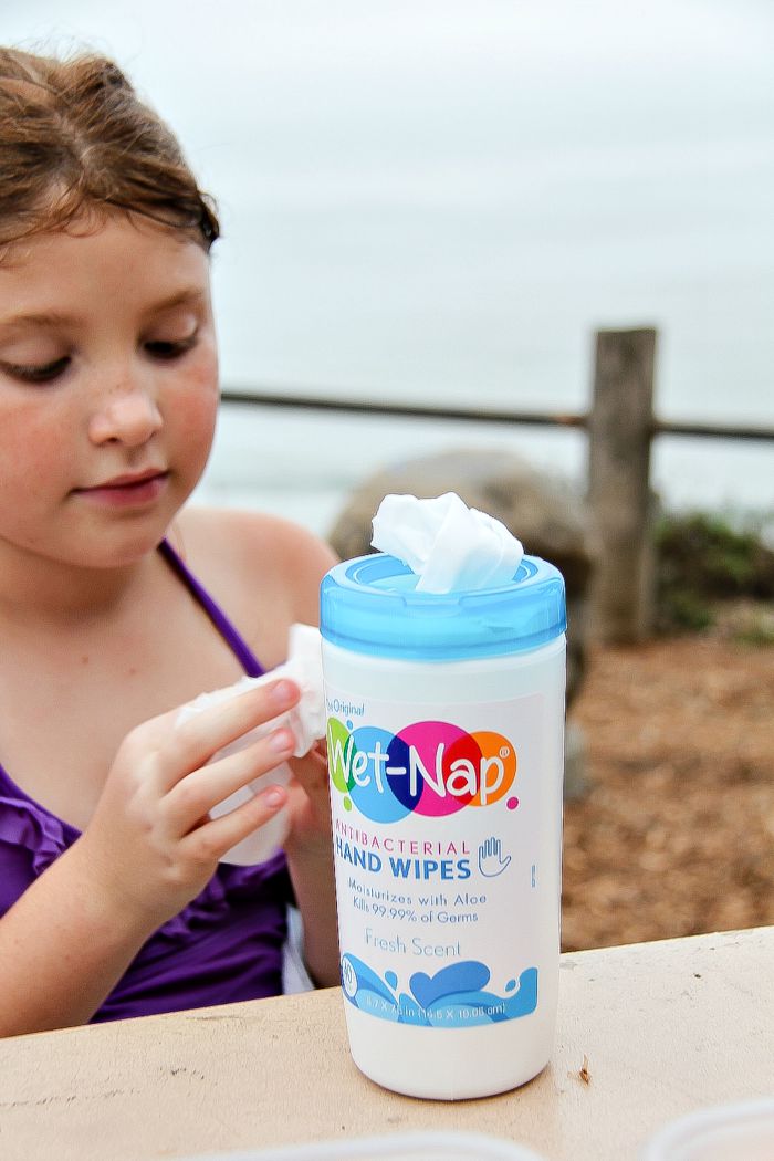 girl using Wet Nap antibacterial wipes