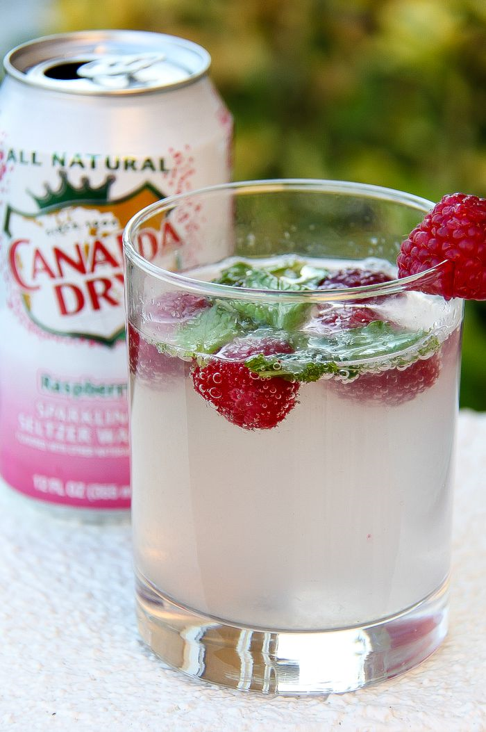 canada dry sparkling raspberry with a cocktail in a glass garnished with fresh raspberries