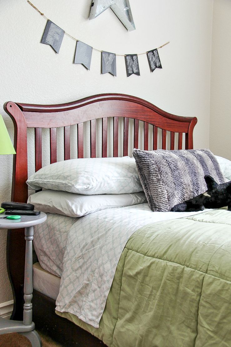 boys bedroom in grey and green with a wood bed