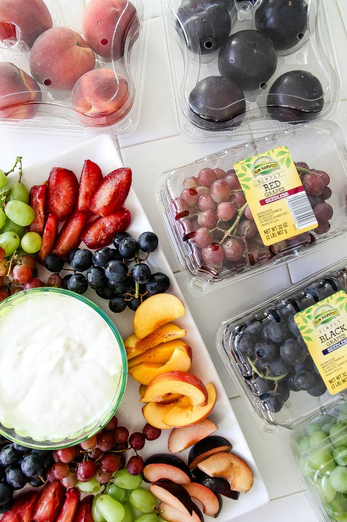 fresh produce in plastic containers and laid out of a platter for a party