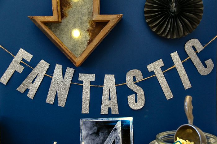 printable fantastic four word banner on a blue background with lighted arrow