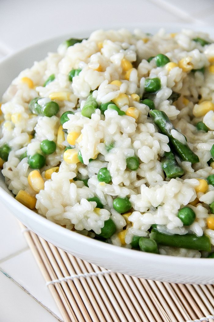 pea, corn, and asparagus risotto in a bowl