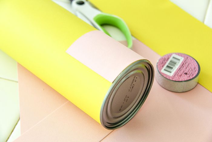 a canister covered in pink and yellow paper to make a pencil