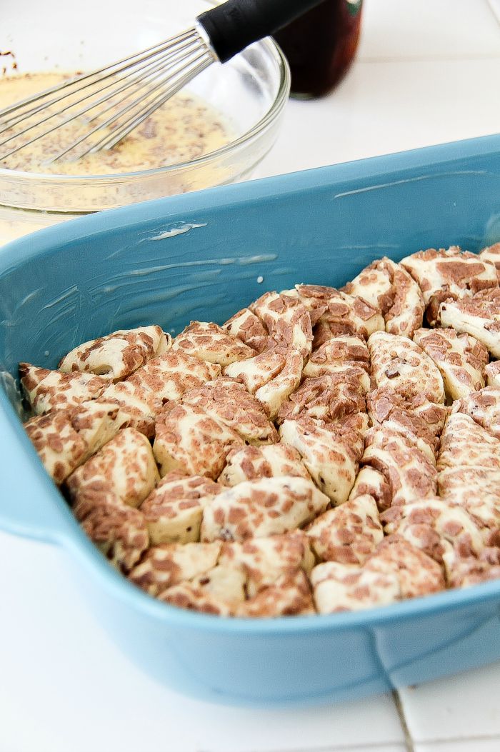 pieces of cinnamon roll in a blue casserole dish