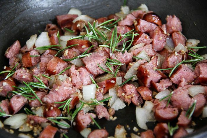 sausage, onion, and rosemary in a pan
