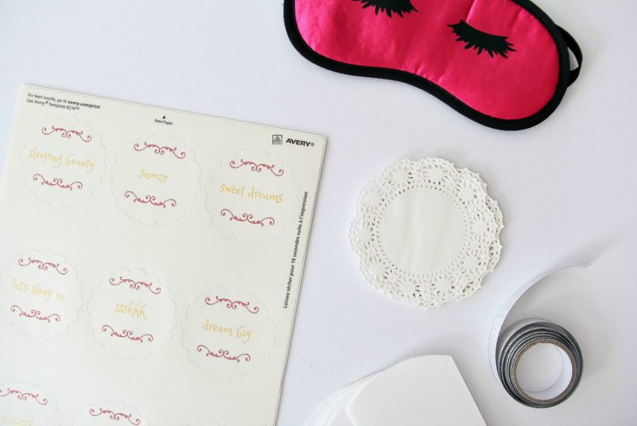 labels, doilies, and a pink sleep mask for a sleepover project