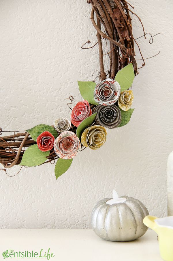 stick wreath with paper flowers in fall colors