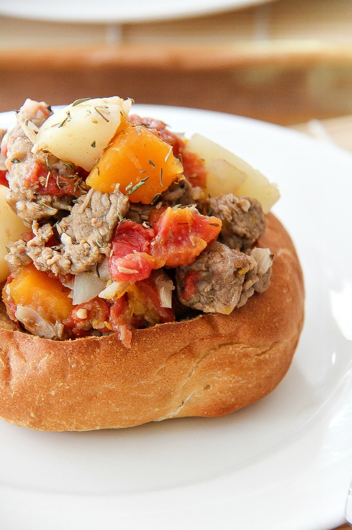 a beef stew in bread bowls