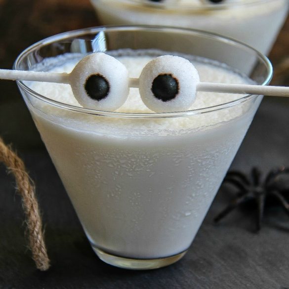 creamy white cocktail in a glass with eyeballs