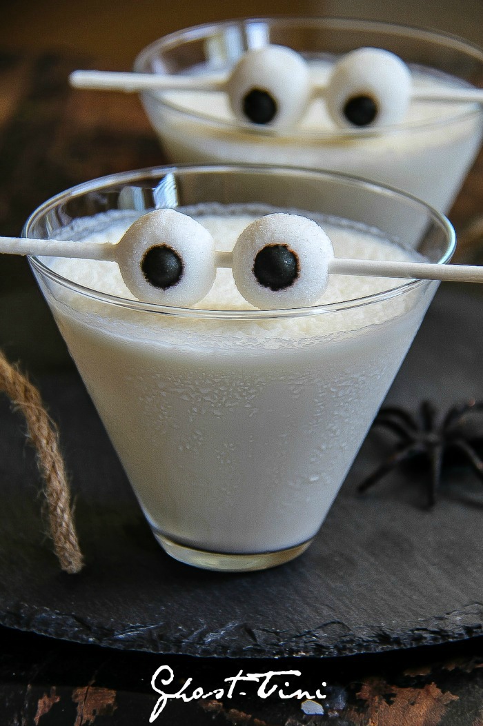 creamy white ghost martini Halloween cocktail in a glass with eyeballs