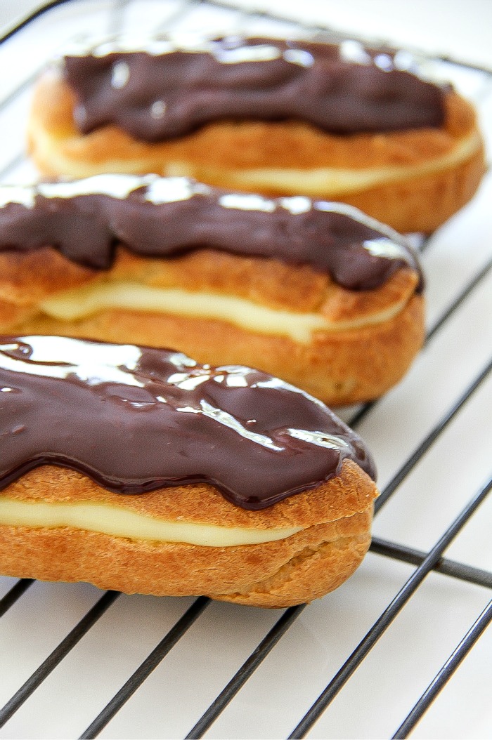 chocolate eclairs on a wire cooling rack