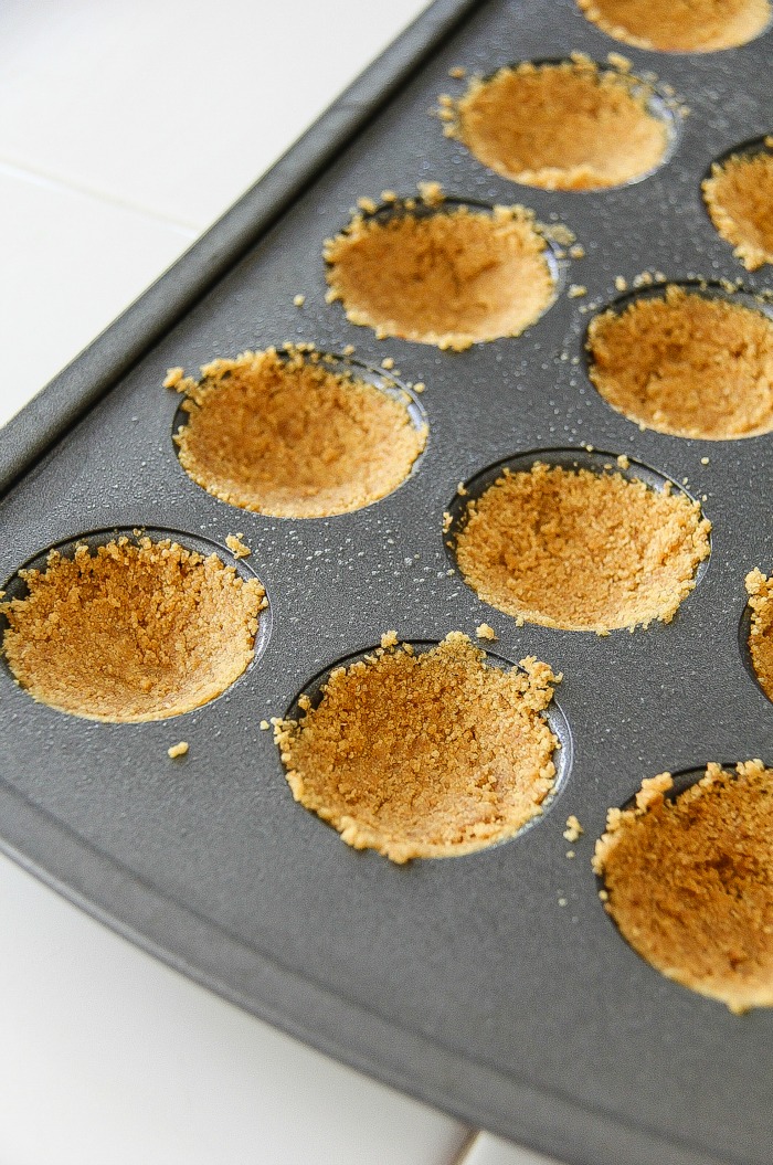 graham crackers pressed into mini muffin pans for baking