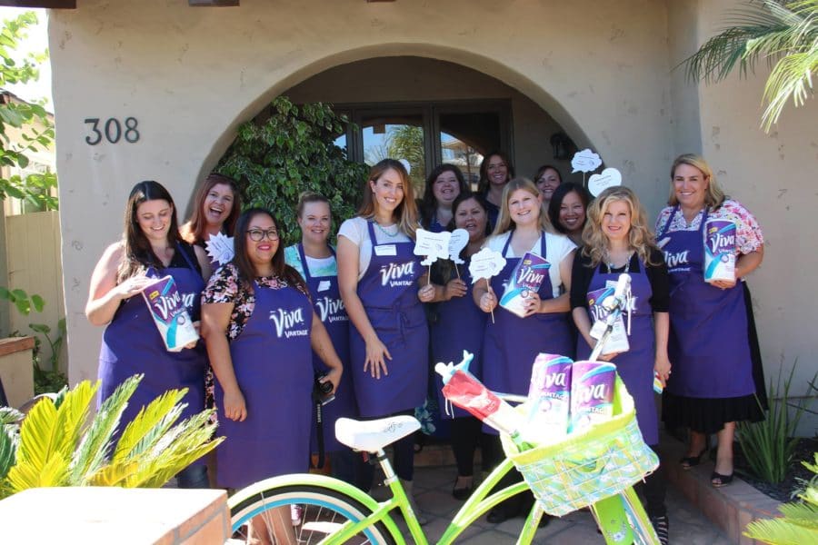 a group of women wearing purple viva paper towels aprons