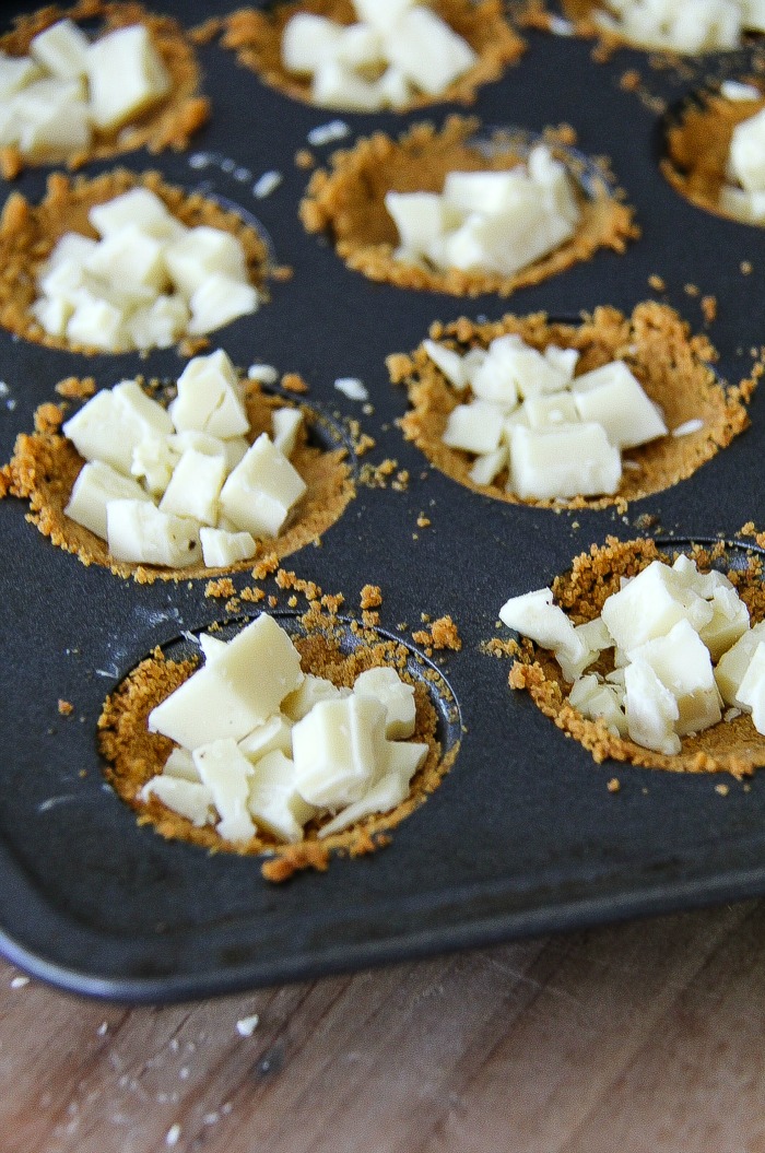 white chocolate in graham cracker cups in a baking pan