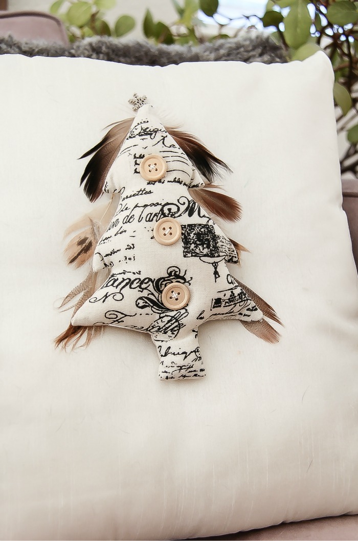 black and white christmas tree with feathers on a white cushion
