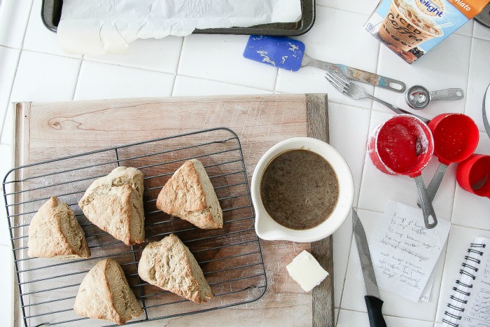 scones on a cooling rack with a jug of caramel sauce to pour over them