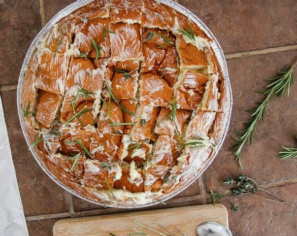 bread with butter and herbs brushed over the top