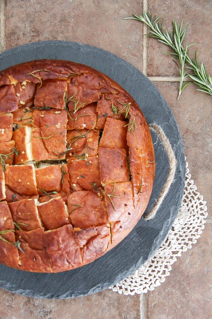 bread with melted butter and herbs over the top