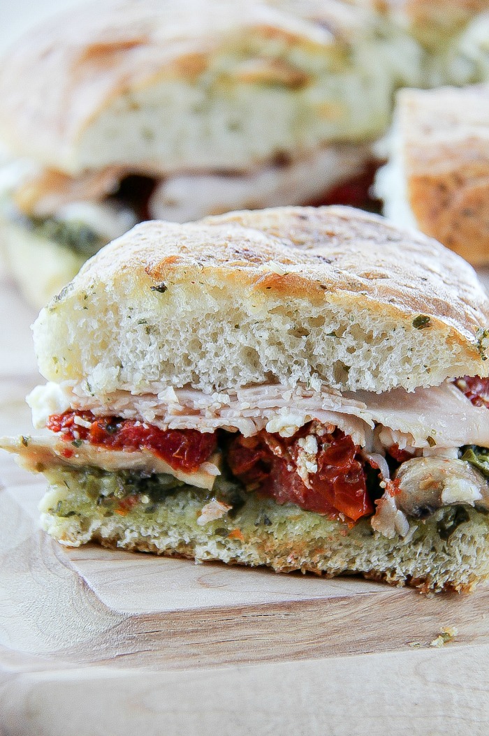 one serving of a turkey pesto sundried tomato focaccia sandwich