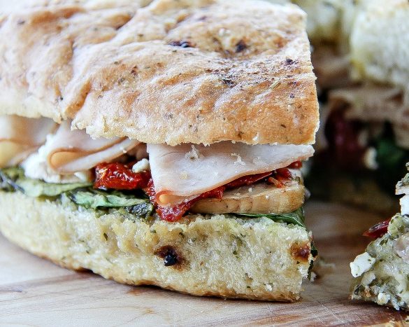 a turkey pesto focaccia sandwich that's been sliced