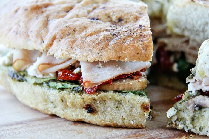 a turkey pesto focaccia sandwich that's been sliced