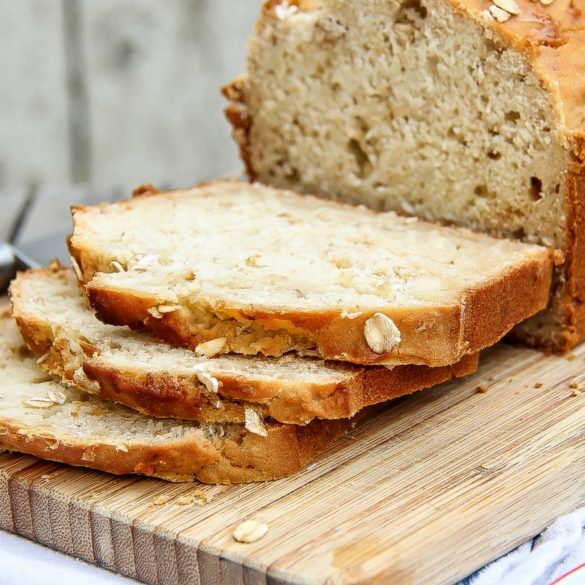 Homemade gluten-free honey oat bread sliced on a cutting board