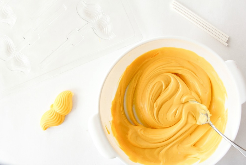 yellow candy melts that have been melted in a glass bowl. 