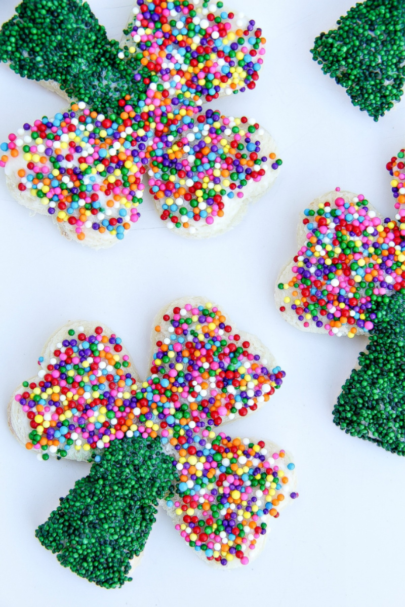 Shamrock shaped fairy bread with rainbow and green sprinkles for St. Patrick's Day.