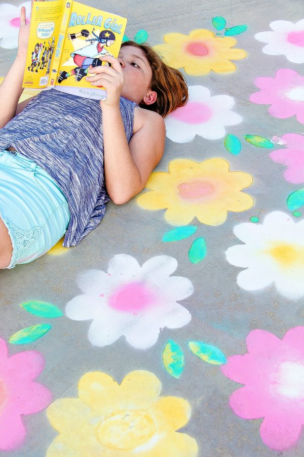 spray chalk flowers painted on a concrete driveway.