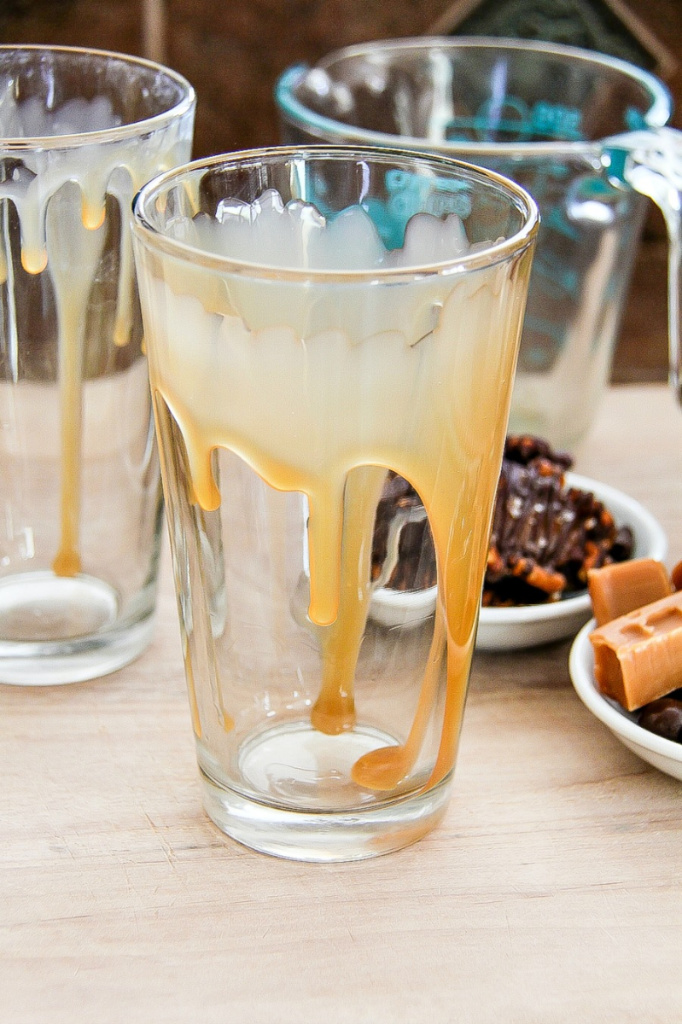 caramel drizzled into a glass for iced coffee