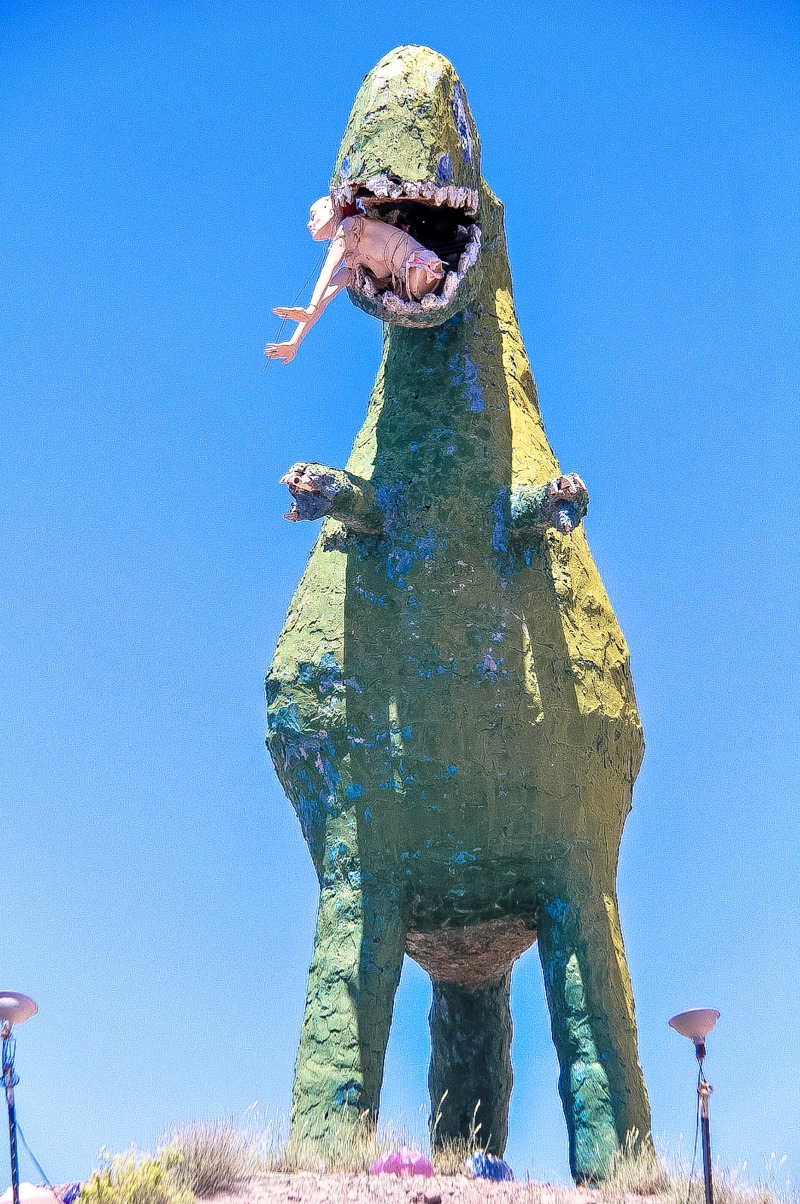 A dinosaur eating a person at Stewart's Petrified Wood in Arizona.