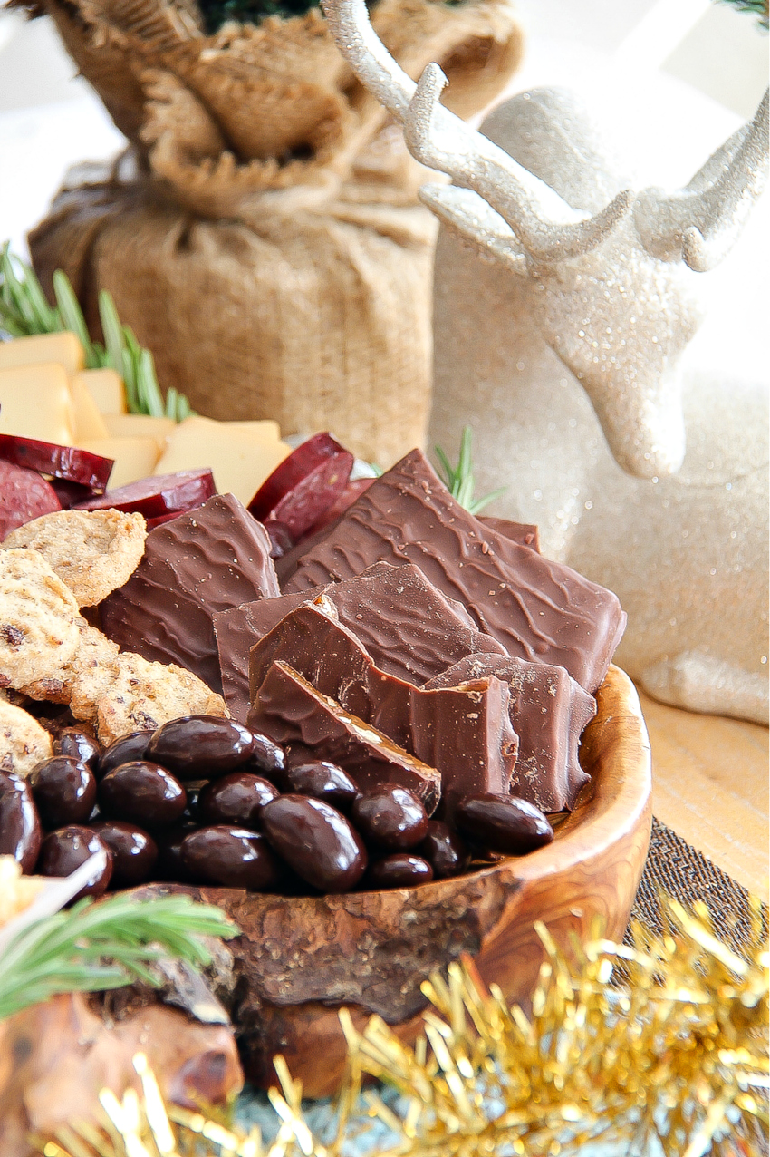 chocolate toffee bark, cookies, and chocolate covered coffee beans on a holiday grazing platter