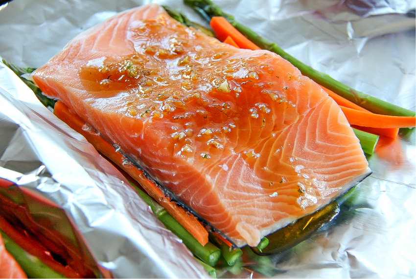 Salmon foil packets with asparagus and carrots with a honey glaze.