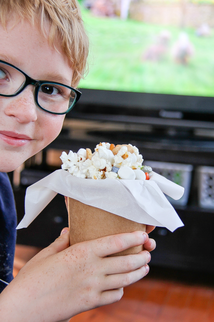 Cardboard treat tub with parchment paper filled with a bunny snack mix for kids.