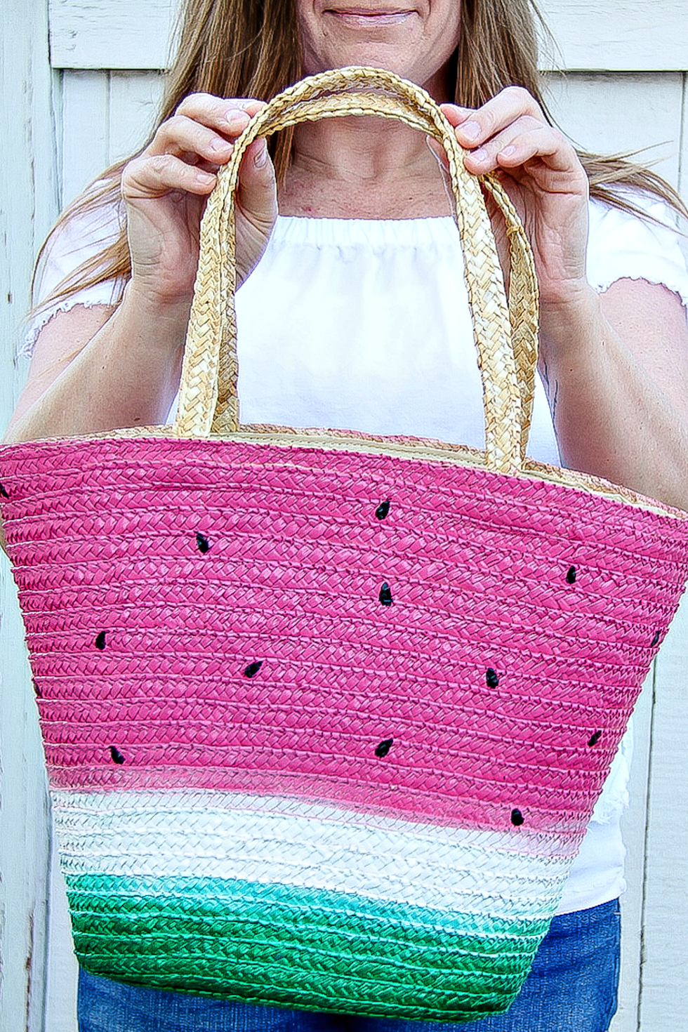 A tote basket that's been painted to look like a watermelon