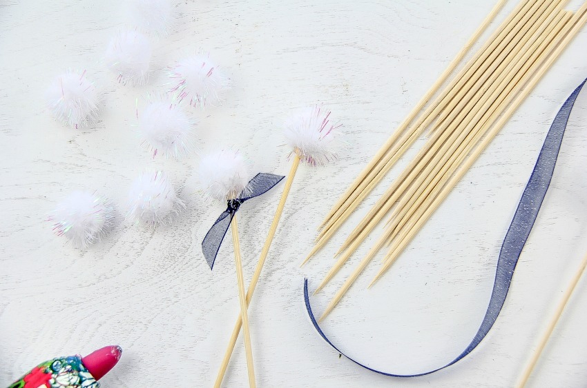 Use wood skewers, ribbon, and pom poms to make bunny tail drink stirrers.