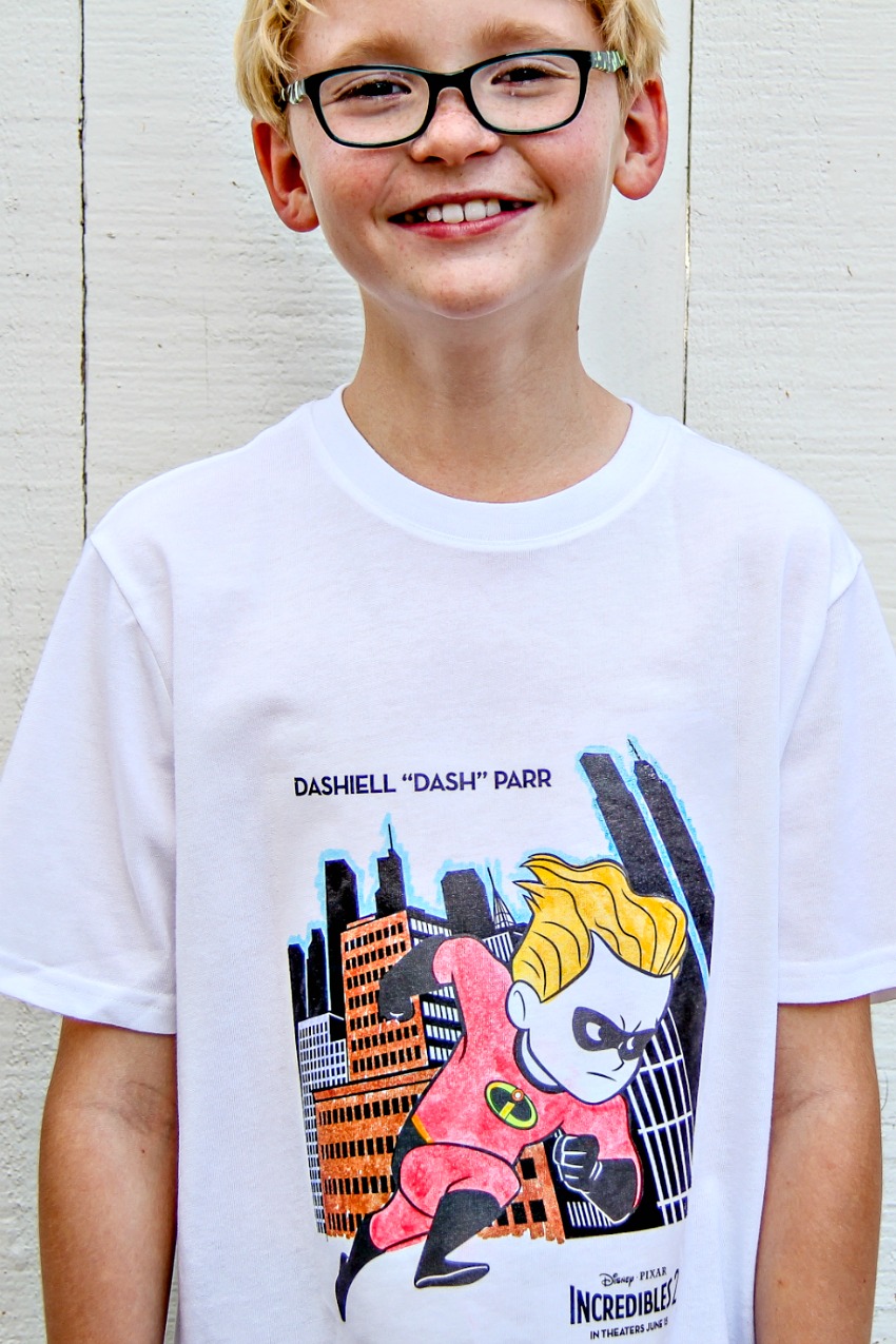 A boy wearing a Disney Incredibles t-shirt made from a coloring page that was colored in with fabric markers.