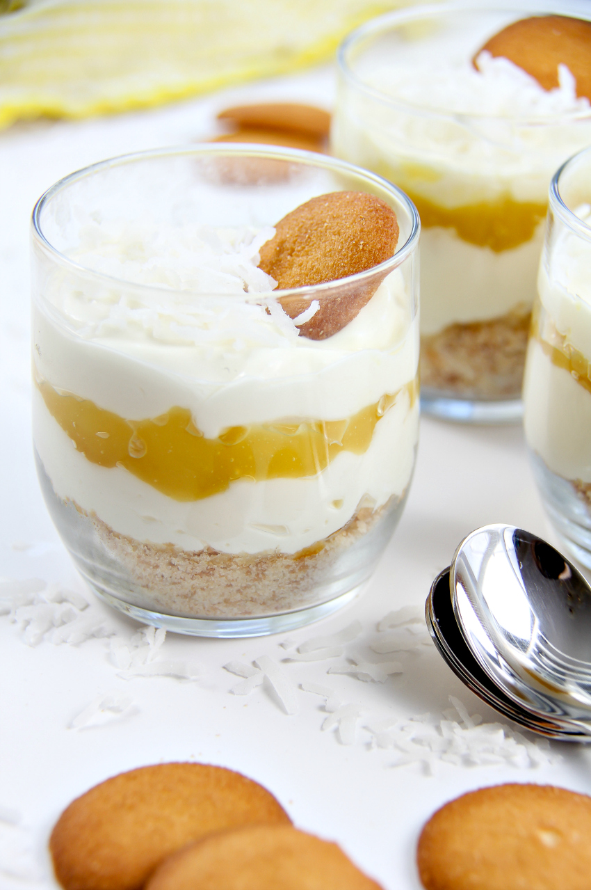 a layered lemon cheesecake dessert in small glasses