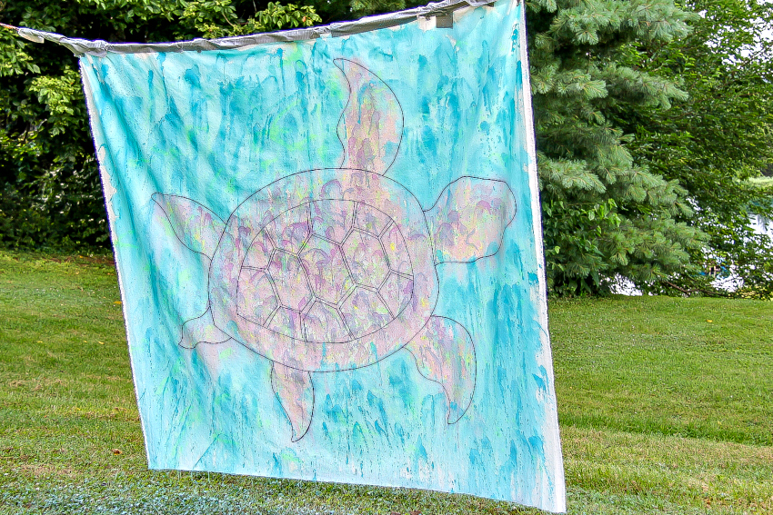 watercolor turtle painted on a canvas with squirt guns