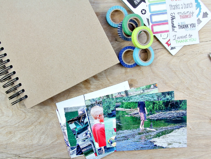 photos, washi tape, and stickers with an album to make a memories scrapbook