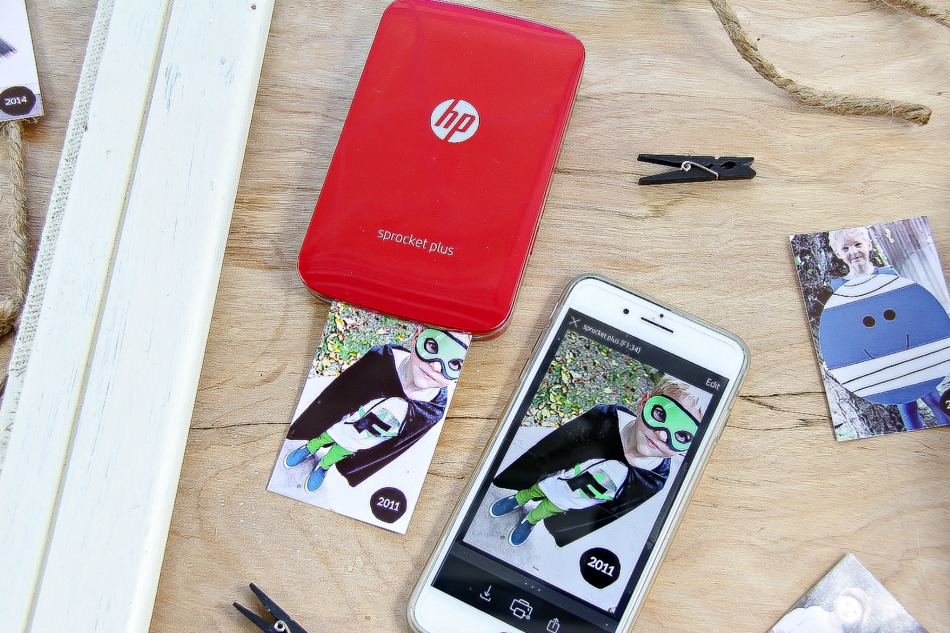 A HP Sprocket Plus printer being used to print Halloween photos.
