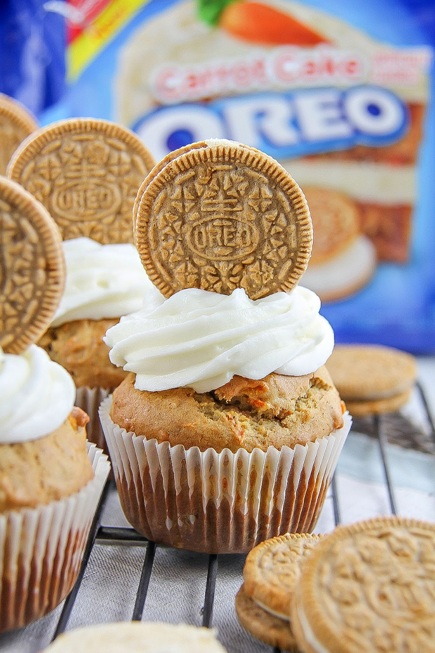 carrot cake muffins topped with oreo cookies and cream cheese frosting