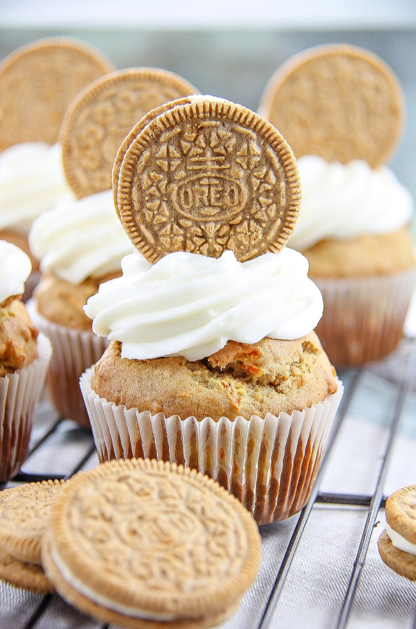 carrot cake muffins topped with cream cheese frosting and OREO cookies