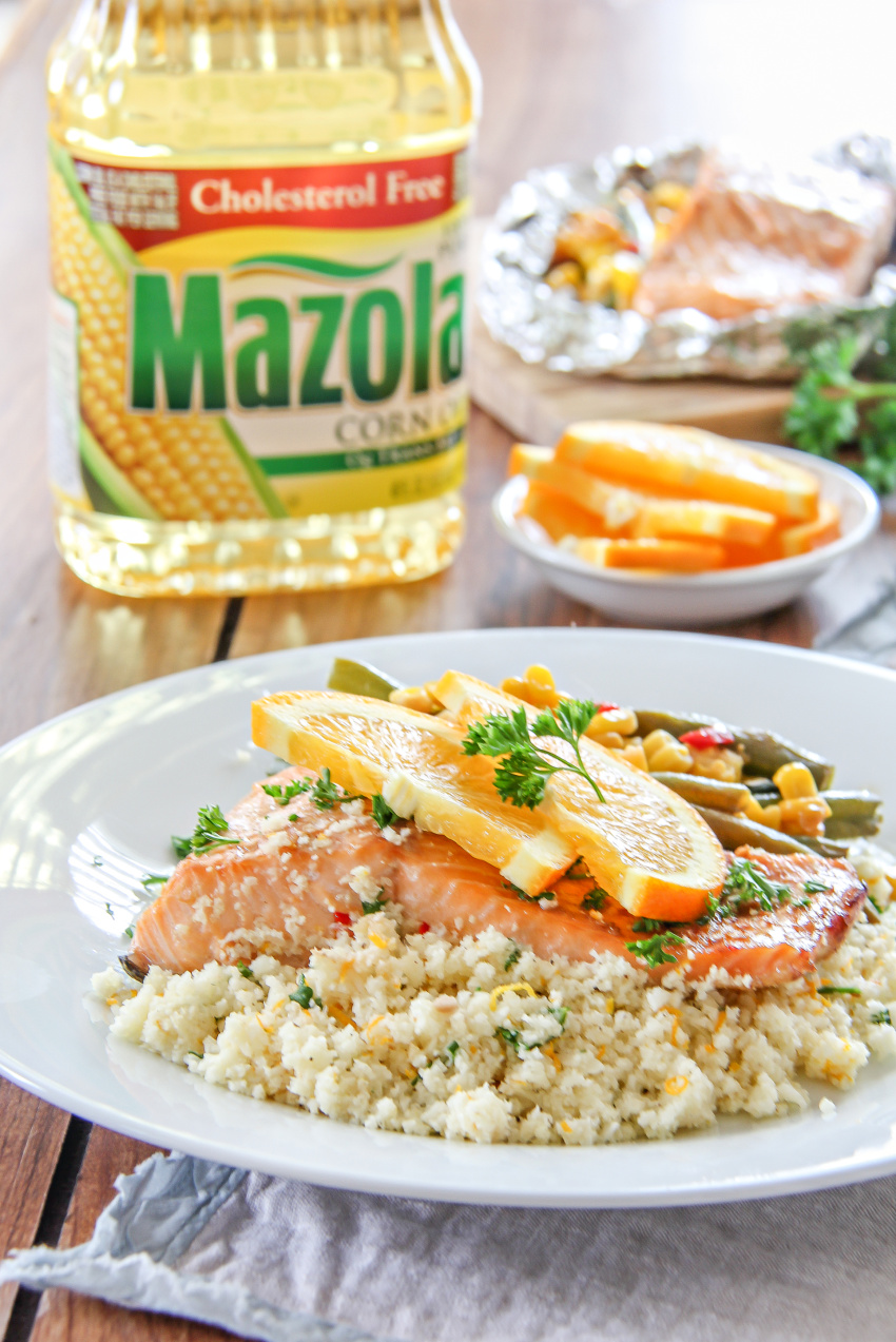 Salmon in foil on grill served with citrus cauliflower rice.