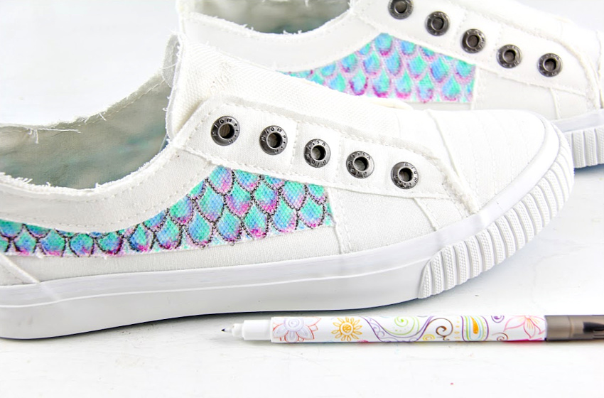 white canvas shoes hand painted to look like a mermaid