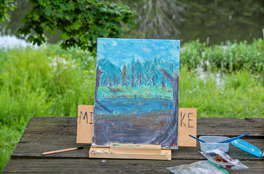 an outdoor painting done in a forest